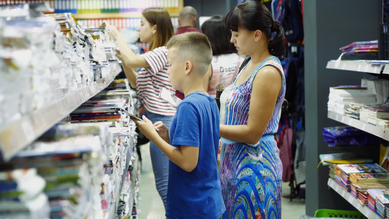 Vinnitsa, Ukraine - August, 2018: Boy choosing buying stationery in store preparing for first day in school.