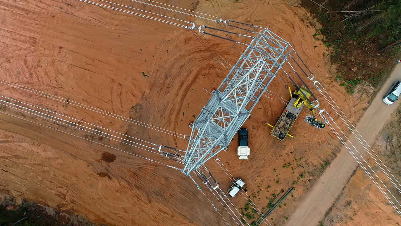 Aerial top down view of new high voltage tower recently installed in the forest