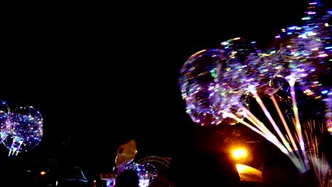 led transparent balloon with multi-colored luminous garland. vivid lights at night.