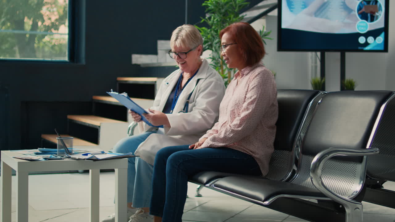 Hospital Staff Assisting Patient in Wheelchair