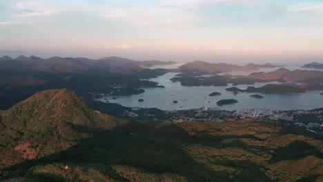 ma on shan coastal town in the shadow of towering mountains aerial pan