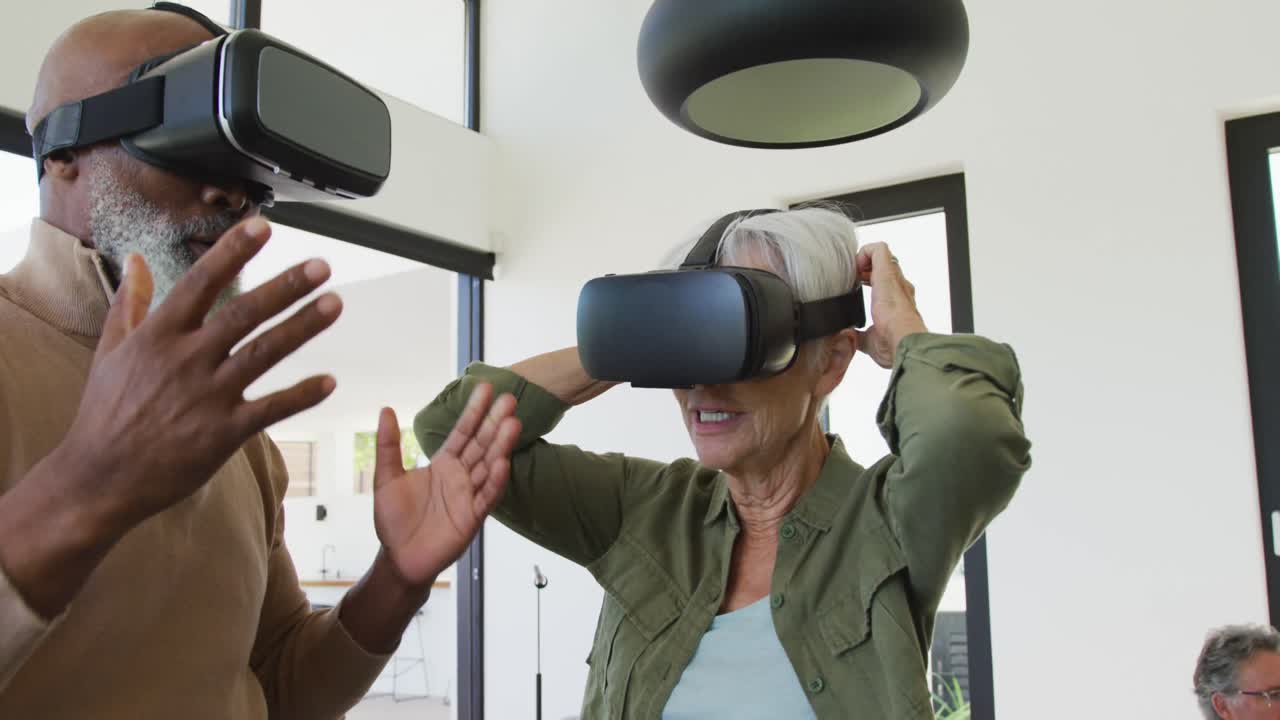 Happy senior diverse people using vr headsets at retirement home