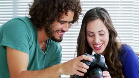 photographer showing photos to fashion model