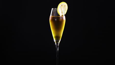 a lemon sour cocktail in a glass against a black background, highlighting its vibrant color and elegant presentation