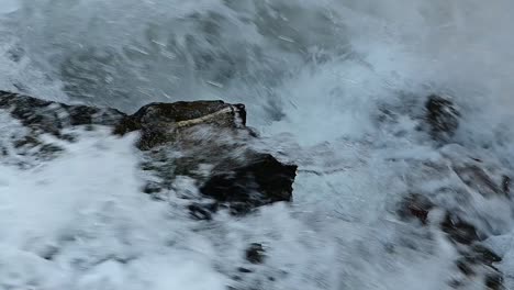 fast water flowing over rocks in the mountain