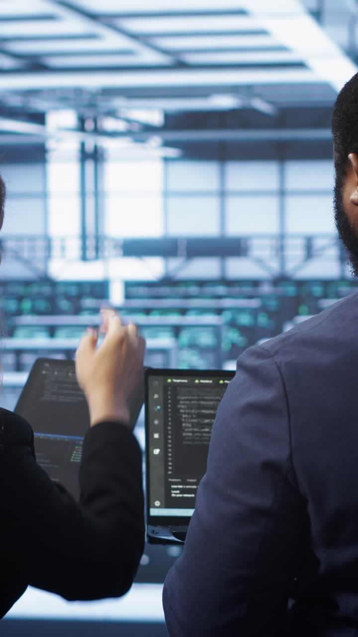 IT Professionals Collaborating on Code in a Data Center