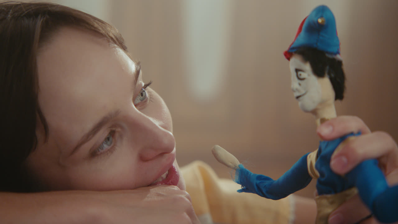A girl playing with dolls in her room