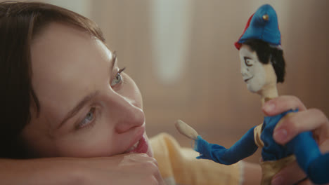 a girl playing with dolls in her room