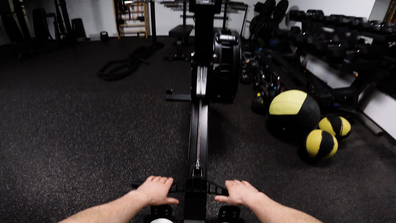 Person Rowing on Machine in Gym