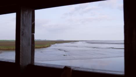 view of a marsh and estuary from a bird hide