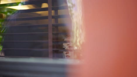 woman looking out a window