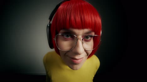 woman with red wig and headphones