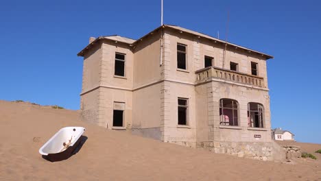 Exterior-establishing-shot-of-abandoned-buildings-in-the-Namib-desert-at-the-ghost-town-of-Kolmanskop-Namibia-5