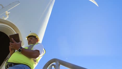 male engineer using digital tablet near in the wind farm 4k
