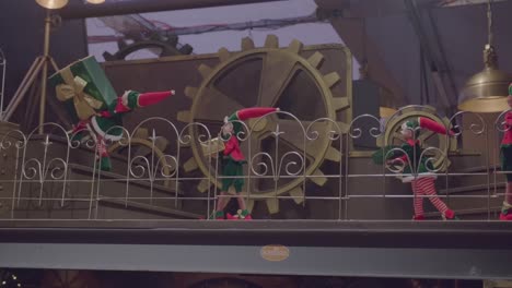 elves carrying christmas gifts with a cog behind in schilliger in gland switzerland