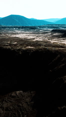 a breathtaking aerial view of a rugged desert landscape with mountains in the distance