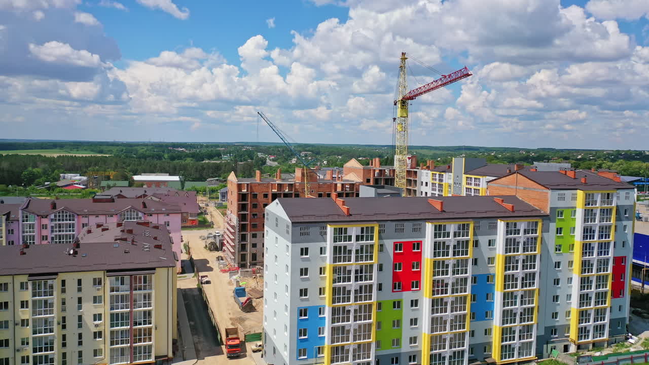 High crane works on building site. Aerial view of construction of multi storey apartment building
