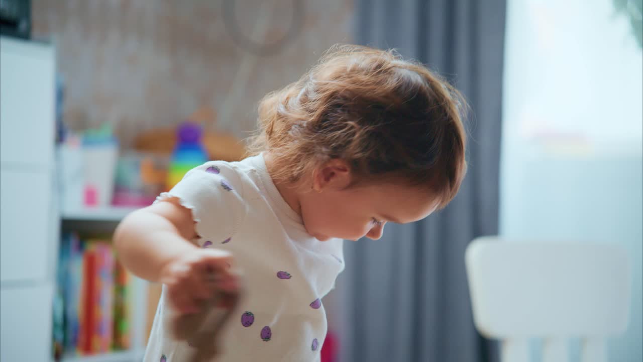 A Curious Toddler Engaged in Playful Activity in a Cozy Room: Exploring Objects with Fascination and Joyful Curiosity