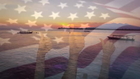 animation of flag of usa blowing over okay hands on beach landscape