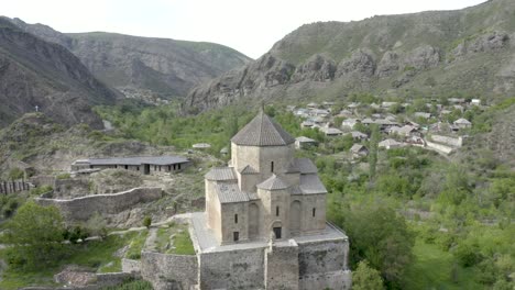 beautiful scenery at the ancient ateni sioni church and tana valley near gori, shida kartli, georgia surrounded in mountain landscape. - aerial orbit shot