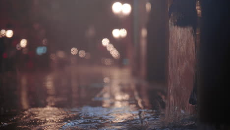 Street-downpipe-with-water-pouring-after-heavy-night-rain