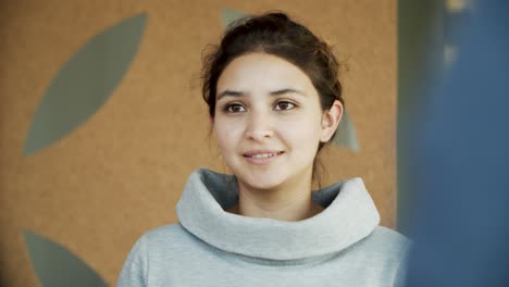 front view of smiling young woman talking