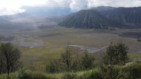 aerial view, in the morning the beautiful mount bromo area is slightly smoky and the savanna is green