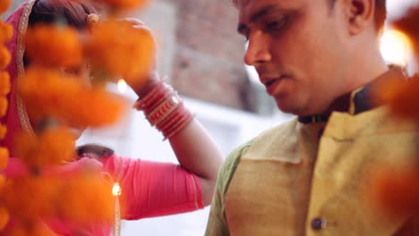 couple celebrate a colorful diwali rangoli- red pink orange green