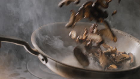 mushrooms being sautéed in a hot pan