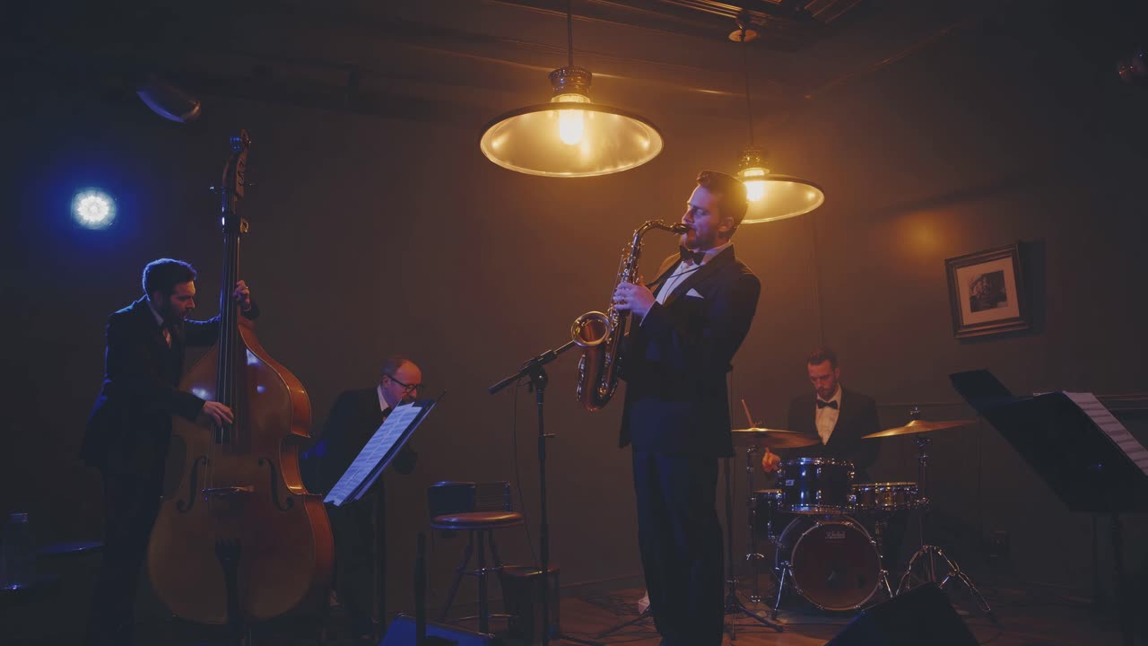 A moody jazz band video scene, captured from a low angle, highlighting musicians in dim lighting