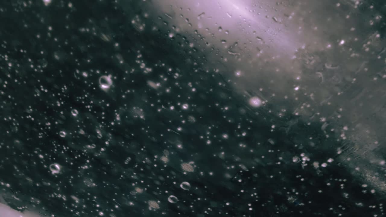 Dark background with floating water droplets and lights