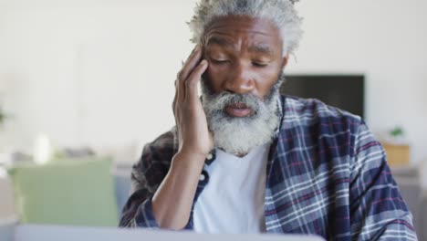Stressed-senior-man-using-laptop-at-home