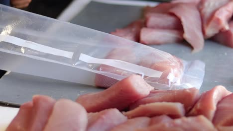 close up of hands packing fresh fish on cedros island, efficient handling and attention to detail as they load filets into vacuum sealed bags after drying pieces