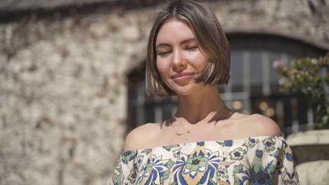 Pretty-short-haired-young-woman-smiles-at-camera,-slow-motion