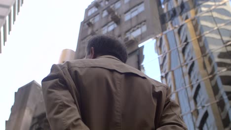 man surrounded by hong kong skyscrapers