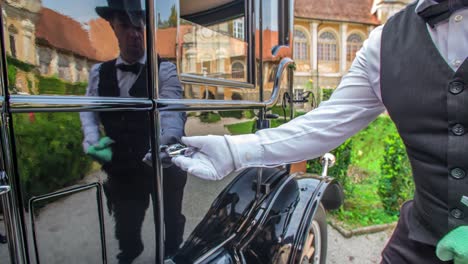 close of a diver cleaning his ford vintage car and open the door to revealing the interior