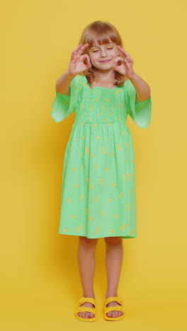 child girl kid looking approvingly at camera showing ok gesture like sign positive good feedback