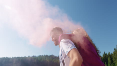 couples having fun with pink smoke bombs