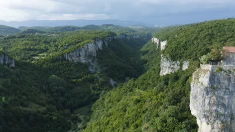 scenic canyon and katskhi monastery on rock pillar in georgia - aerial drone shot