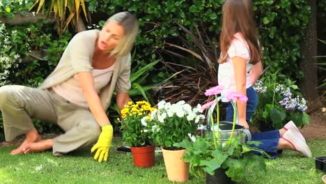 young girl and mother doing some gardening