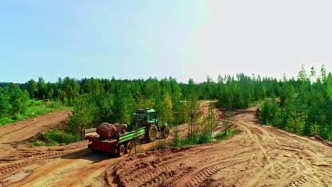 -Static-shot-of-dumper-truck-carrying-heavy-stone-through-wet-muddy-brown-soil-clay-road-with-truck-tire-tracks