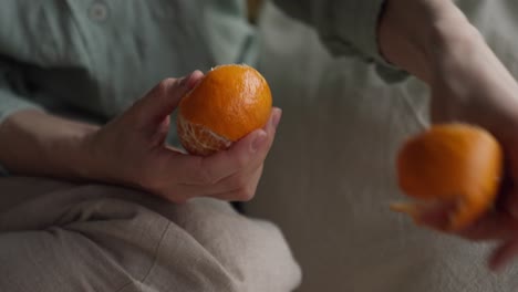 woman peeling an orange