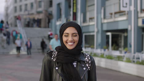 portrait of attractive young middle eastern woman laughing happy enjoying city life