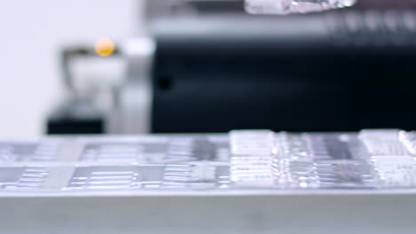 pharmaceutical packaging machine. medical ampoules on conveyor belt