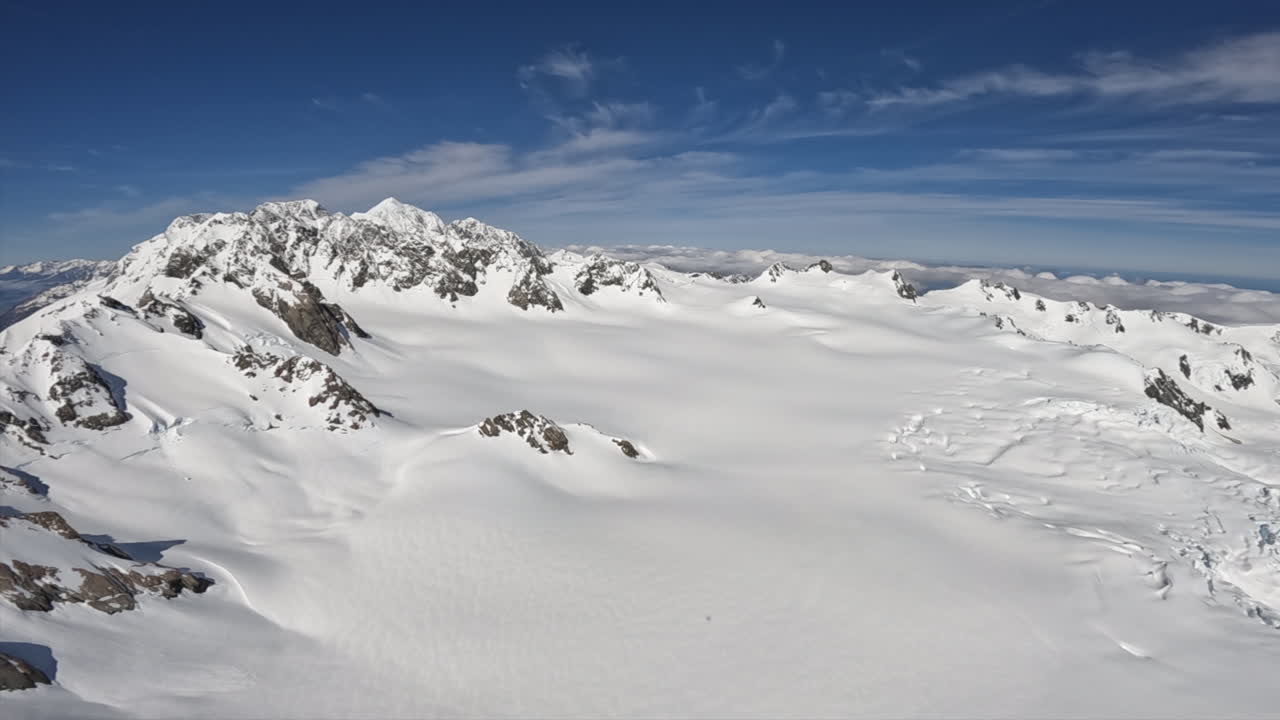 Aerial shot of Snow covered mountains stretching for miles, Southern Alps New Zealand