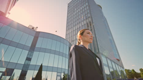 posh businesswoman standing sunlight looking at distance. woman boss posing