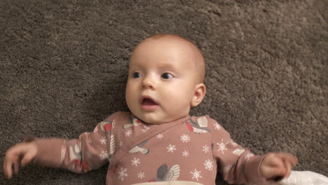 cute baby girl on floor, top down view