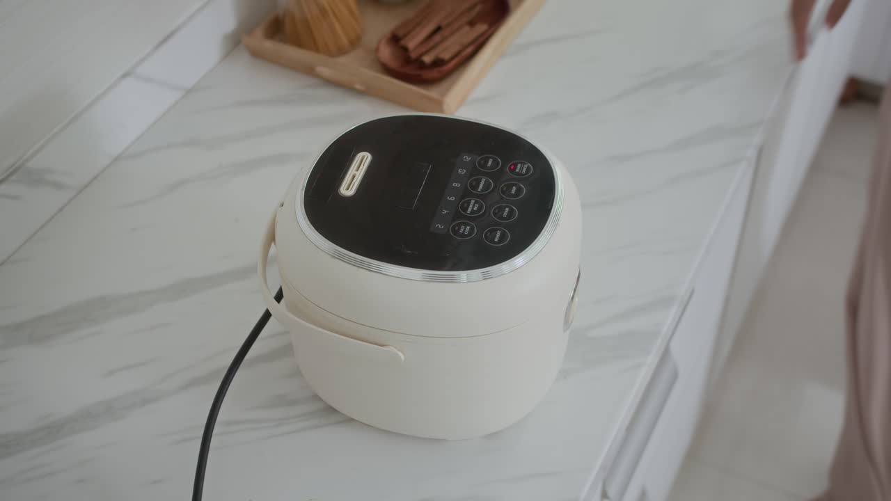 Hands of Housewife Boiling Rice in Multicooker