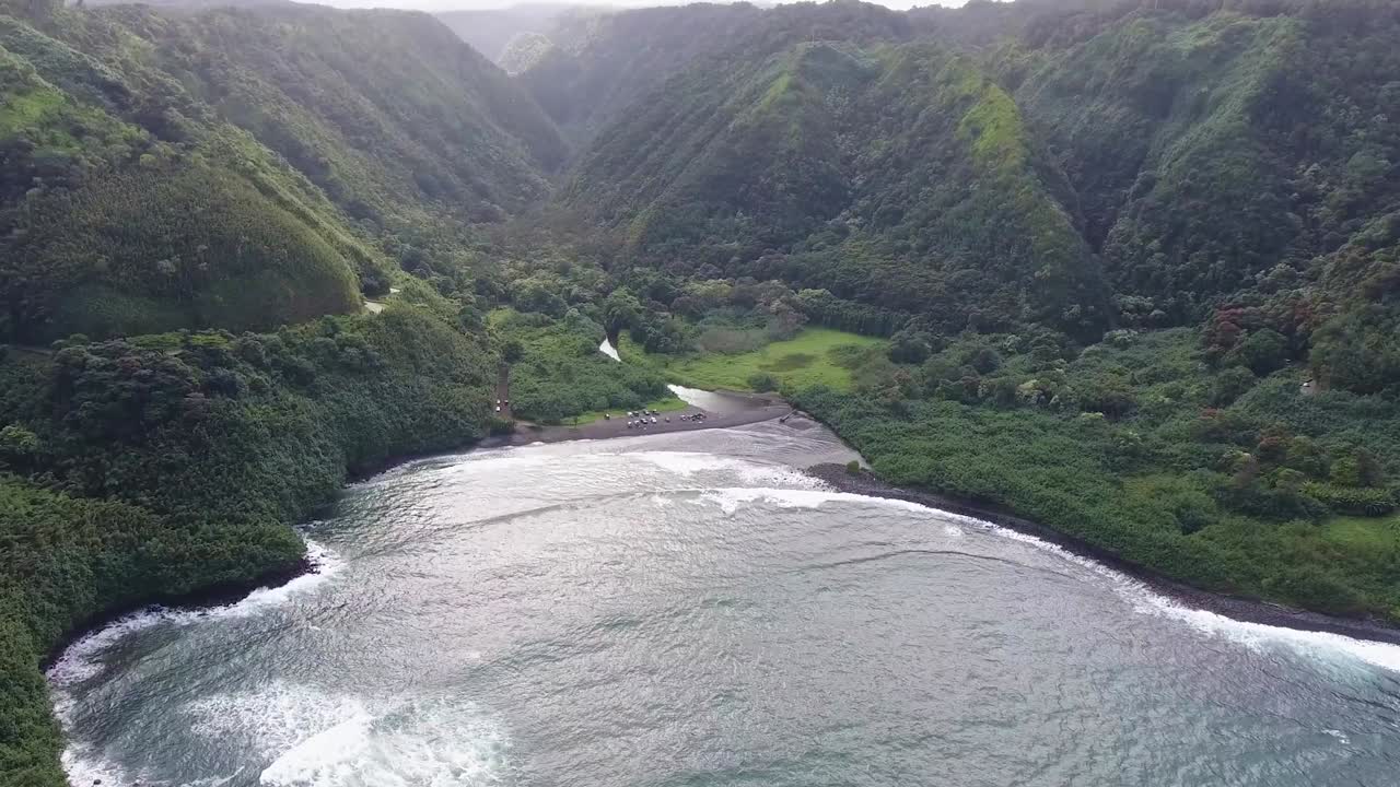 Approaching beautiful Honomanu Bay next to Hana Highway, on Maui Hawaii, aerial