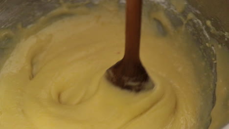 children making a cake at home, close-up soft focus, slow motion